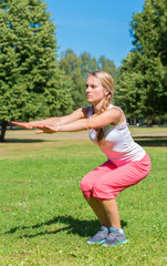 Fototapeta premium Young woman stretches before doing sports.