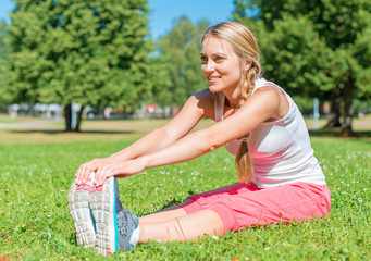 Young woman stretches before doing sports.