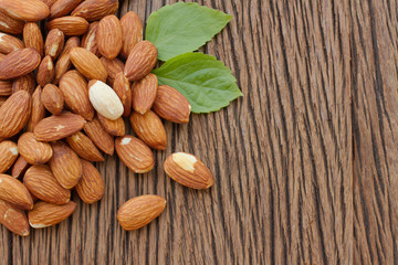 Almonds  with leaf on wooden background