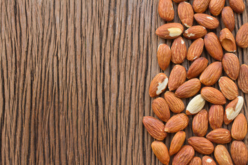 Almonds on wooden background