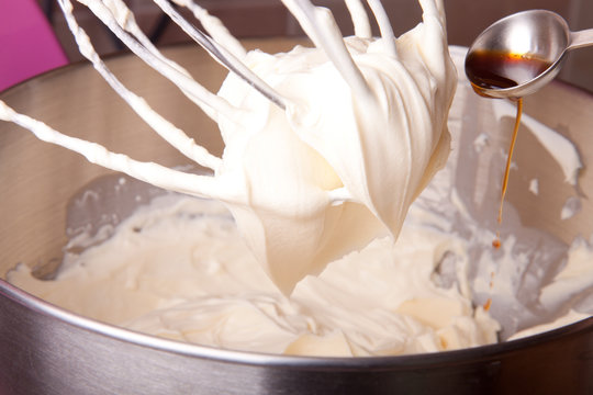 Pouring  Vanilla Extract To Cream