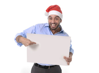 handsome man in santa christmas hat pointing blank billboard