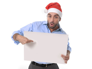 business man in christmas hat pointing blank billboard