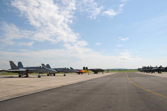 Miitary aircraft parked on the runway at an airshow