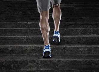Close up of young man running up the stairs