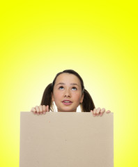 Trendy young girl holding to a blank card