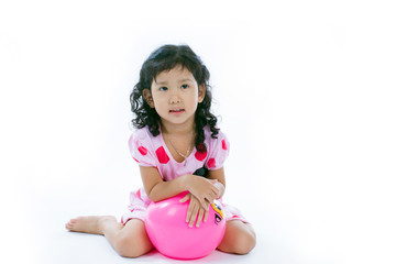 Obraz na płótnie Canvas Happy asian girl playing ball on white background