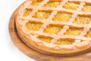 pie with fruit filling on a white wooden background, close-up