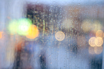 window rain blurred city lights