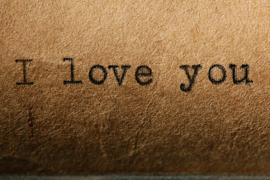 love is, the inscription on a typewriter