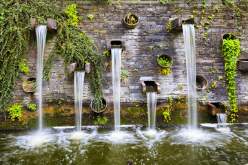 Rocky wall with small waterfalls in Planten un Blomen park