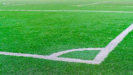 Obraz premium White stripe on the green soccer field from top view