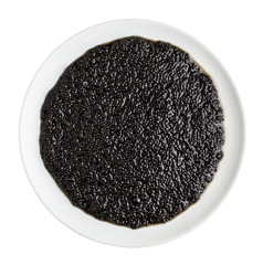 Black caviar in a white plate isolated on white