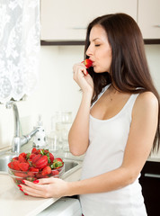 Woman eating strawberries