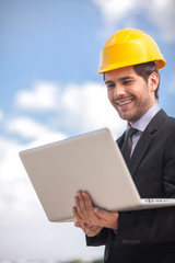 handsome architect man holding laptop.