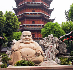 Smiling buddha statue in front of a distorted Ruigang pagoda, Su