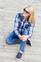 beautiful teenage girl sitting on wooden floor