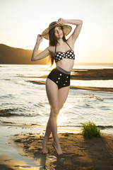 Beautiful woman in bikini on sunset background