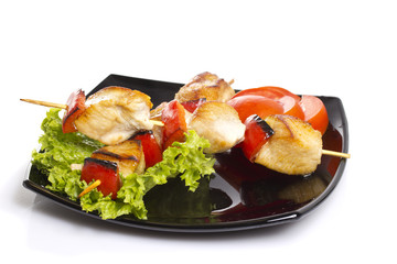 Chicken pieces grilled on skewers isolated on white background