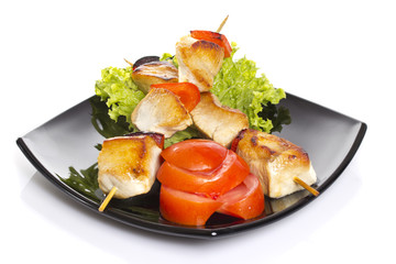 Chicken pieces grilled on skewers isolated on white background