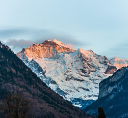 Obraz premium Top of ice mountain touching by sunlight