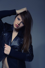 Fototapeta na wymiar Fashion girl, portrait of young woman posing at studio, toned