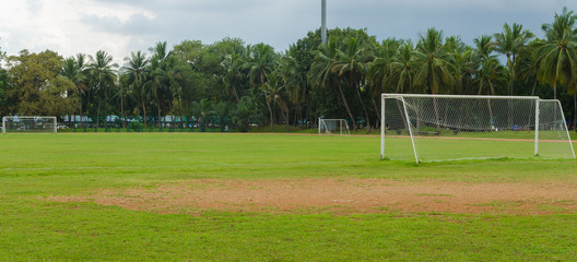 Fototapeta premium soccer goal at the end of a empty field at a park