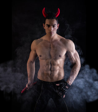 Sexy Young Man Wearing Horns and Tail as Devil