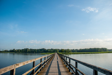 long wooden bridge over the lake