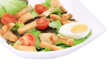 Caesar Salad with eggs and tomatoes.