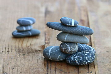 stones on wooden background balance concept