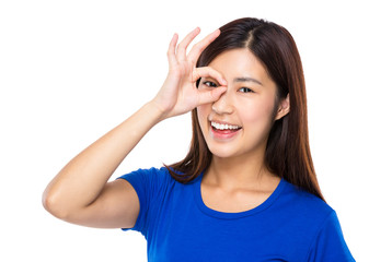 Woman with ok sign cover her eye