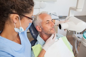 Dentist taking an xray of patients mouth