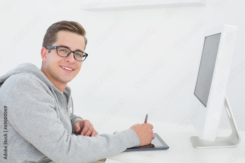 Poster Casual man working at desk with computer and digitizer