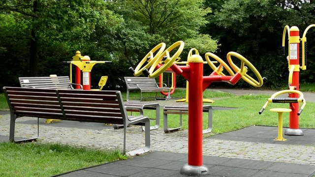 senior park (exercise machines) with benches - in the park