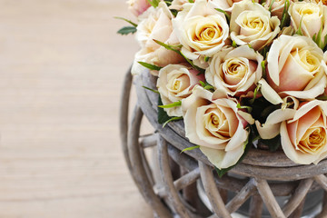 Bouquet of roses in wicker basket, copy space