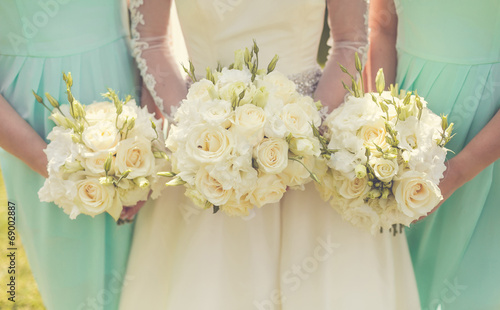 Bride with bridesmaids holding wedding bouquets