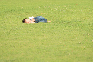 Fototapeta na wymiar Little girl laying on the grass