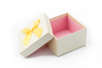 Gift box present with yellow ribbon isolated on white background
