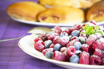 Dessert with raspberry, blueberry and bun