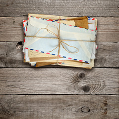Bunch of old envelopes on wooden background