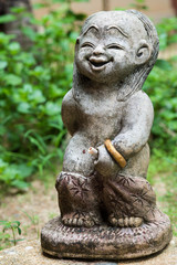 Fototapeta premium Little boy statue in a garden