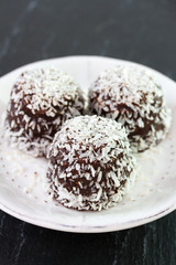 chocolate coconut sweets on white plate