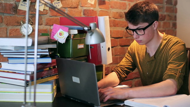 Angry student finish working on laptop at home