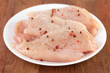 chicken breast with pepper on white plate