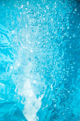 Blue swimming pool water ripples and bubbles