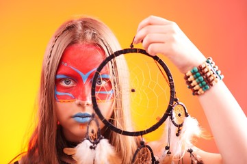 Beautiful indian teen girl with make-up holds dreamcatcher