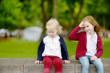 Fototapeta na wymiar Two adorable little sisters outdoors