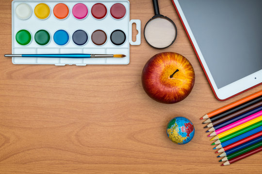 School Supplies On Wooden School Desk From Above