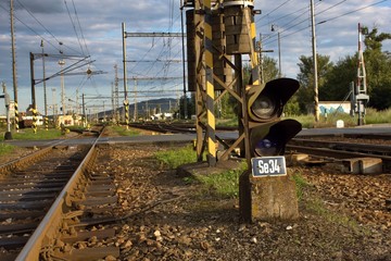 Traffic light shows red signal on railway. Blue light